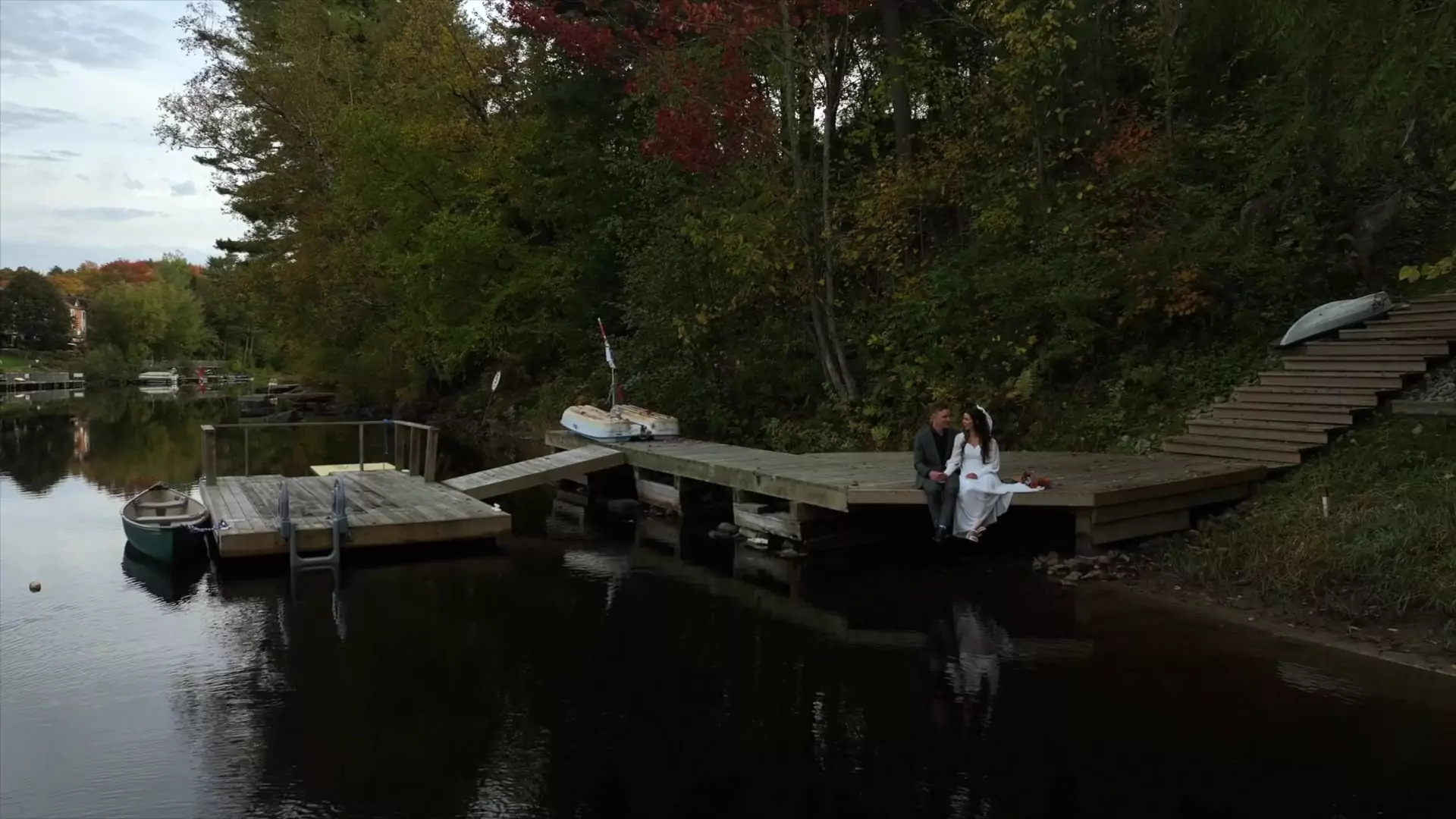 Krista & Mitch sitting for a quient moment on the dock after their ceremony.